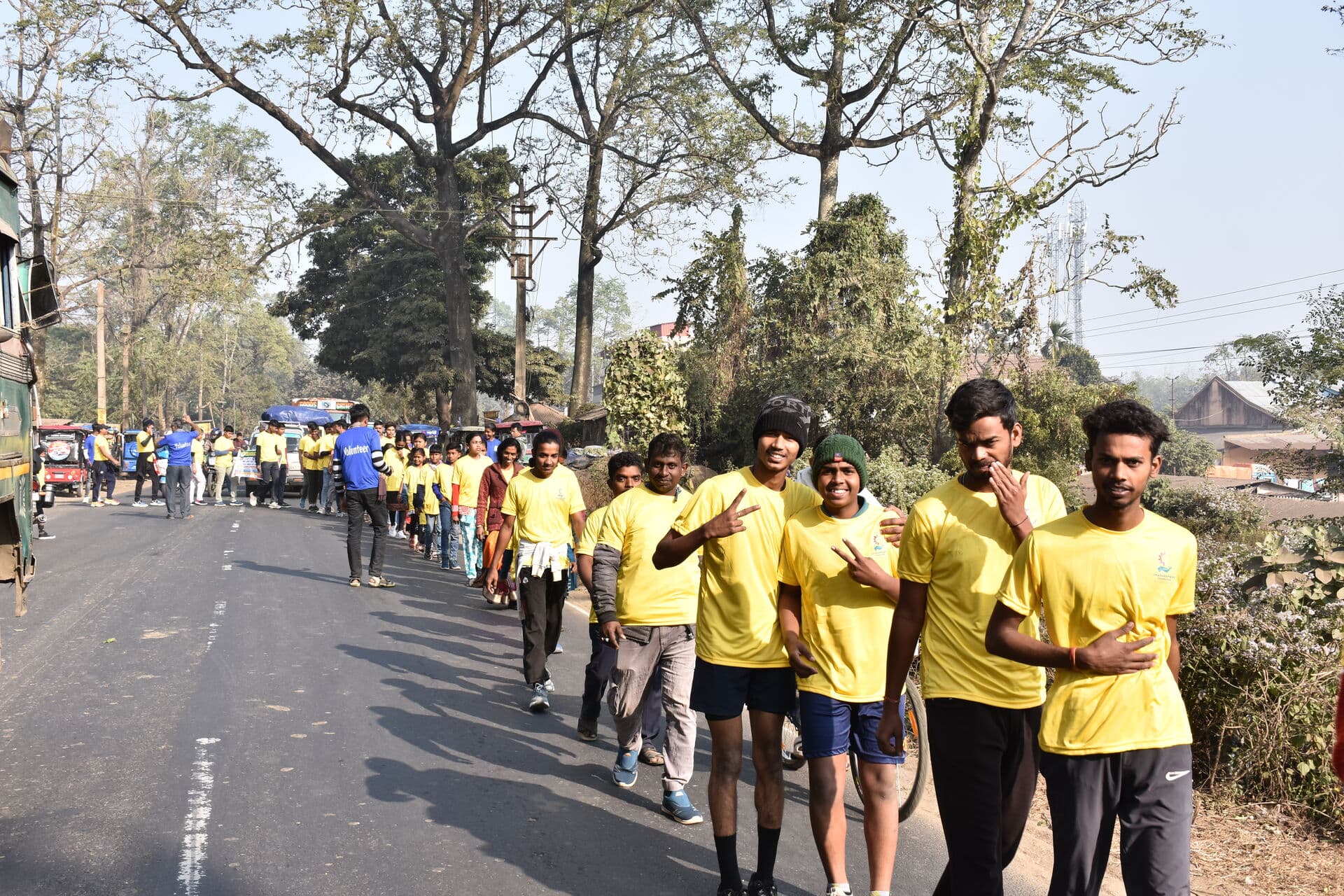 Long line of participants walking through Arambagh